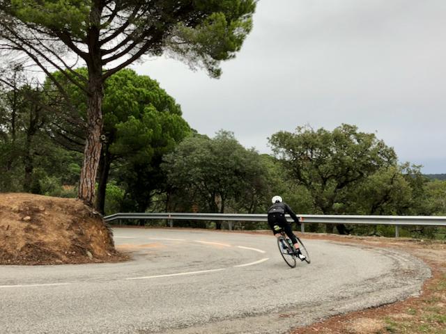 Cyclist descending down towards Tossa Del Mar near Costa Brava in Spain