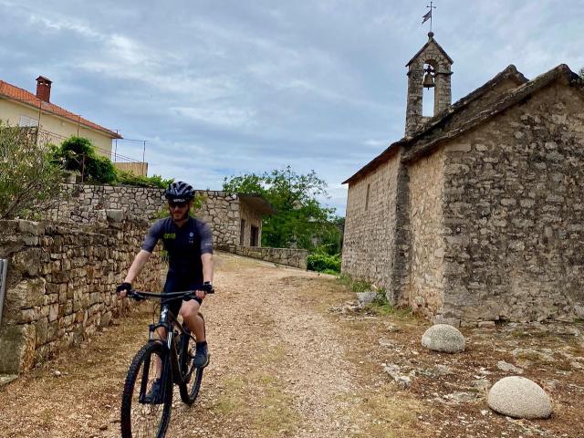 Cyclist riding near Vrisnik, Croatia