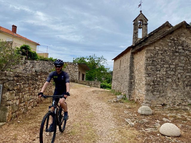 Cyclist riding near Vrisnik, Croatia
