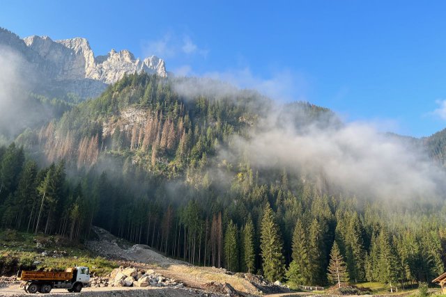 Early morning sun and fog in the Dolomite mountains near Alleghe, Italy