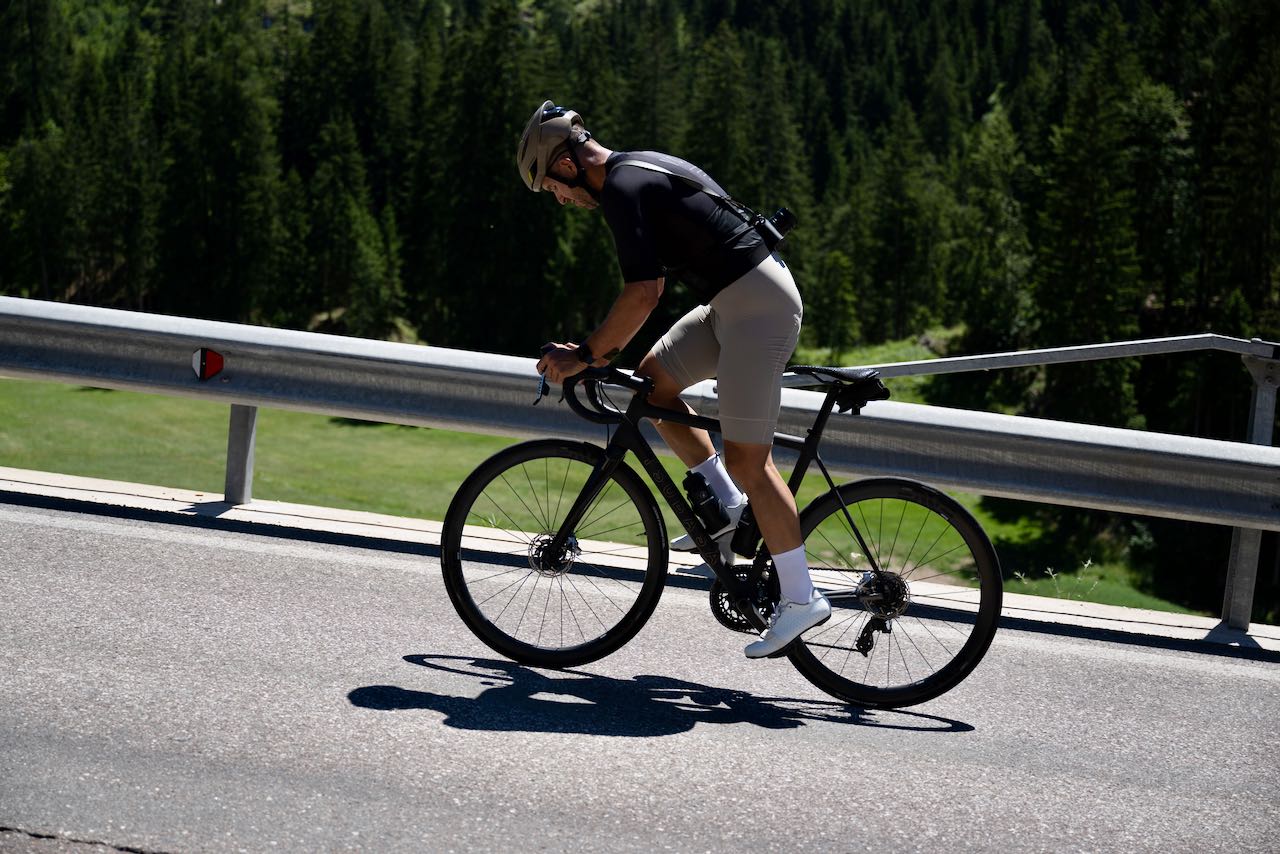 Cyclist from Velodrom.cc riding near Lago di Carezza in the Italian Dolomites