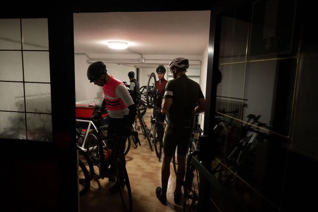 Cyclists getting ready for an early morning ride before sunrise at the Sporthotel Europa in Alleghe, Italy