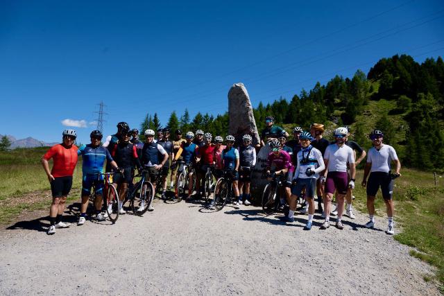 Group photo of many cyclists at the top of the Mortirolo climb with Velodrom's Italian Job cycling camp