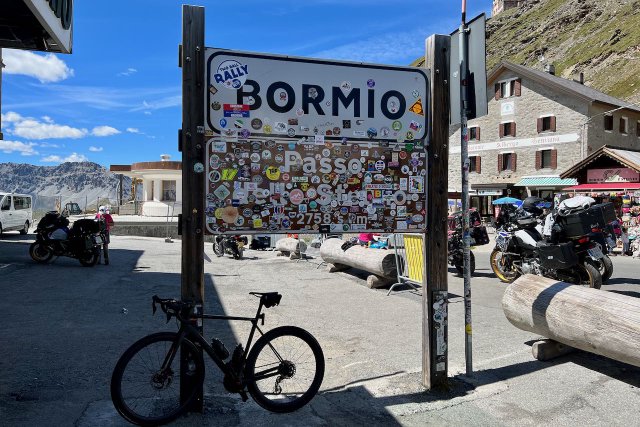 Stickers taking over the sign at the top of the Passo dello Stelvio