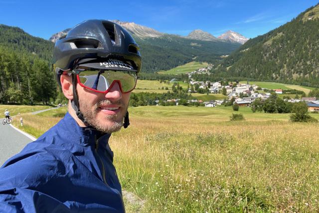 Cyclist selfie with view out into Switzerland near Santa Maria Val Müstair