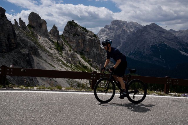 Cyclist climbing out of the saddle up the Tre Cime di Lavaredo climb