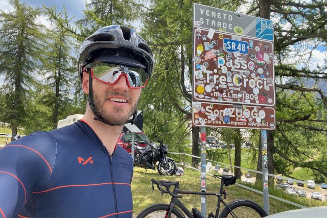 Road sign full of stickers for the Tre Croci pass in the Italian Dolomites