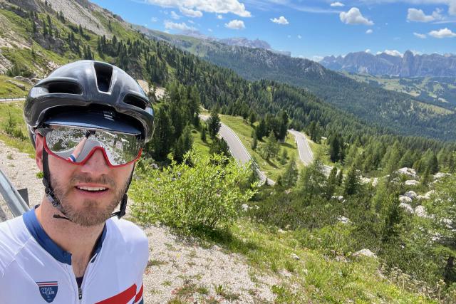Cyclist selfie picture with roads below near the top of the Passo Valparola