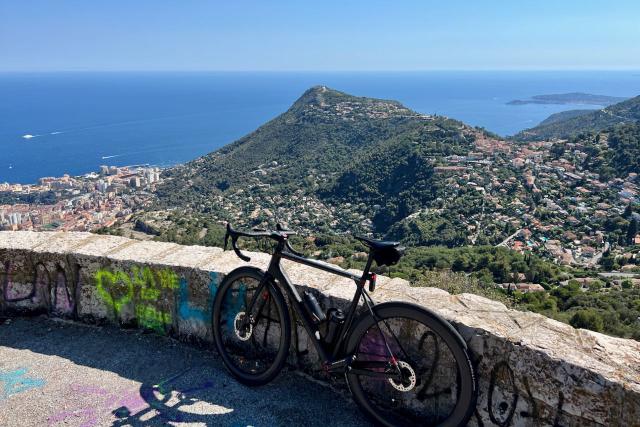 Factor O2 VAM bicycle leaning against wall near Mont Agel with view over Mediterranean Sea