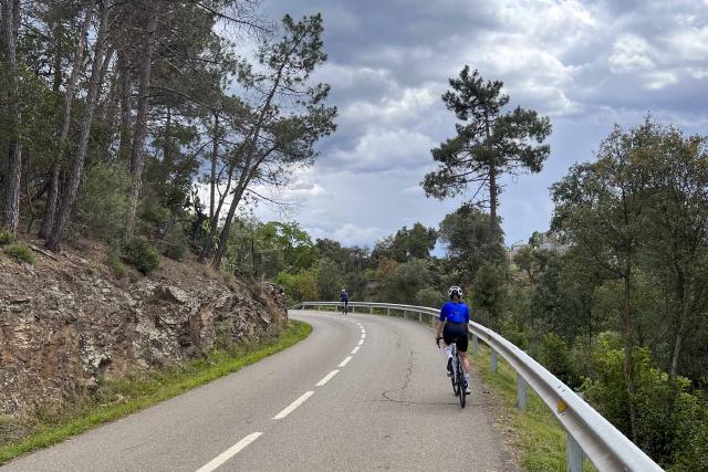 Cyclist riding near Serres in the Girona region of Spain.