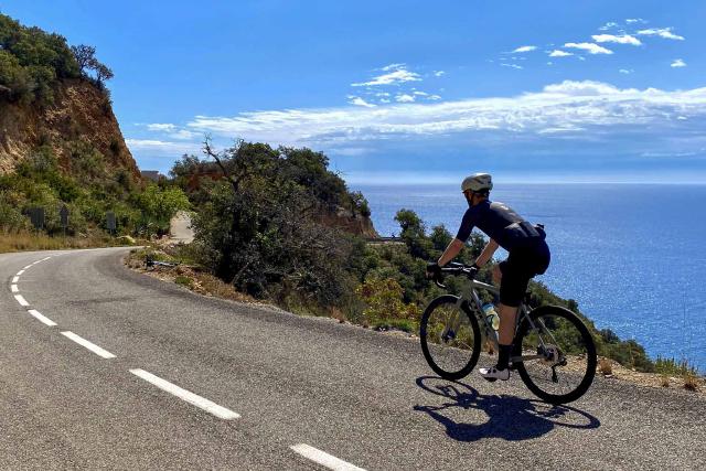 Cyclist overlooking the Costa Brava on the way to Sant Feliu de Guíxols
