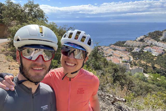 Cyclist couple posing along the road to Sant Feliu de Guíxols along the Costa Brava.