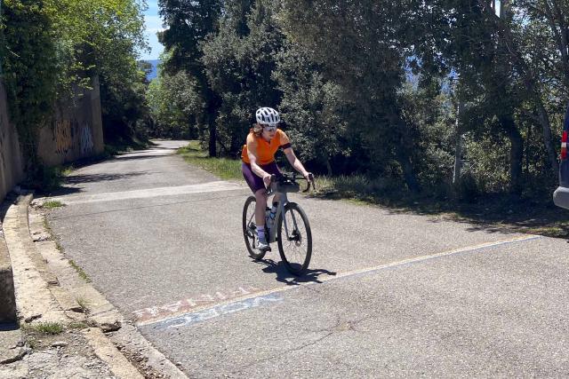 Cyclist crossing the finish line at the top of Rocacorba in Girona, Spain.
