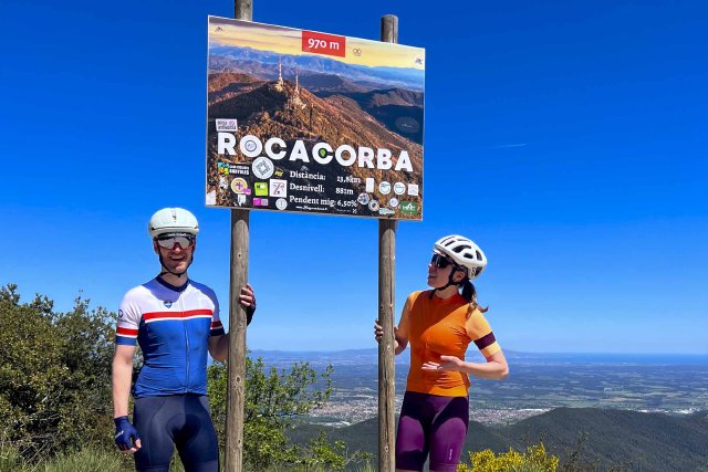 Two cyclists posing at the top of the Rocacorba climb in Girona, Spain.