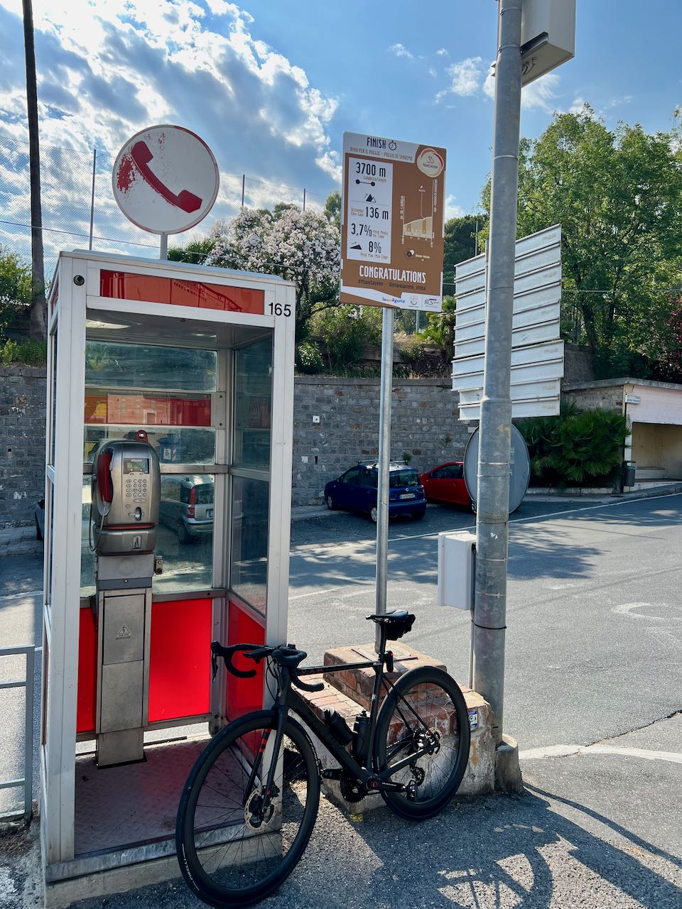 Bicycle with phone booth at the top of the Poggio climb in Italy