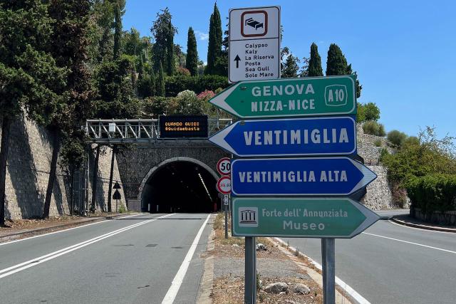 Sign to Ventimiglia, Italy in front of a tunnel along the frontage road