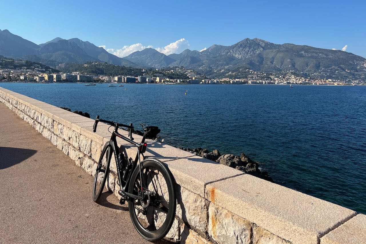 Bicycle leaning against a wall overlooking Menton and the South of France, viewed from Cap Martin