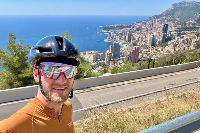 Cyclist along corniche road overlooking the country of Monaco