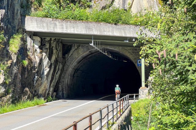 Cyclist entering a tunnel on the way to the Sustenpass climb near Wassen