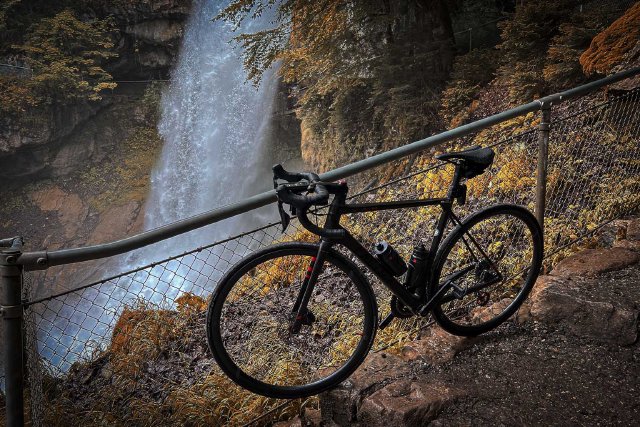 Bicycle hanging off a railing next to Giessbach falls