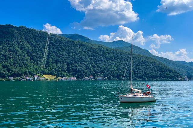 Swiss flag on a small boat in the lake at Marcote, Switzerland
