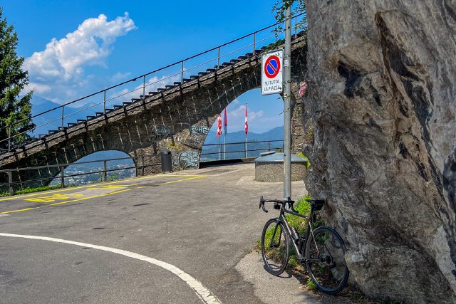 Bicycle in a bend in the road to Monte Brè next to the funicular track