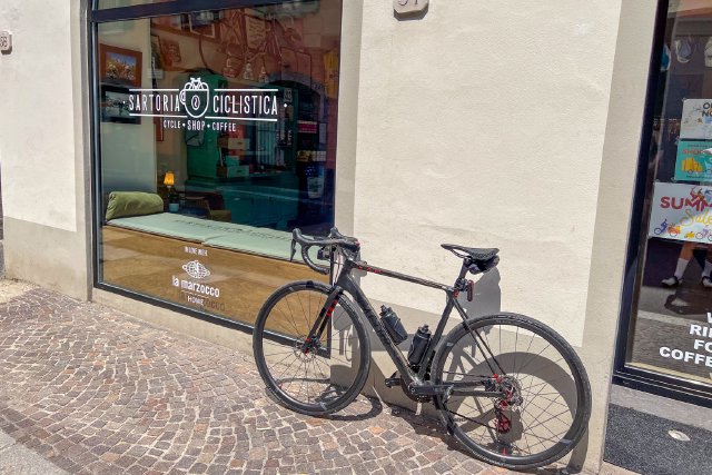 Factor bicycle sitting outside Sartora Ciclistica, a bike shop in Como, Italy