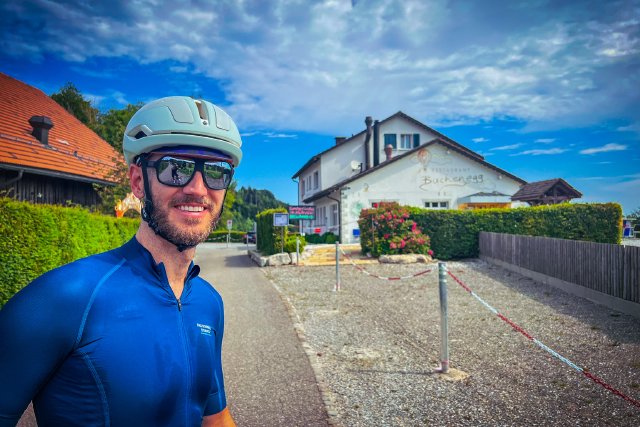 Cyclist standing outside the Restaurant Buchenegg in Zürich, Switzerland