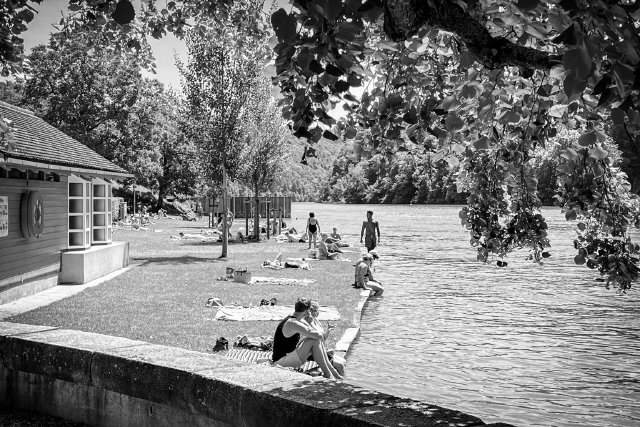 People out enjoying the banks for the Rhine river near Eglisau, Switzerland.