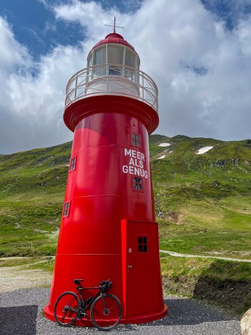 Didn't expect to see something like this here! Lighthouse atop the Oberalppass with a Factor bicycle leaning against it