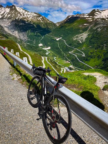 Not every day you can look out over two world-class climbs at once! Viewpoint from the top of the Grimselpass looking out over the Furkapass