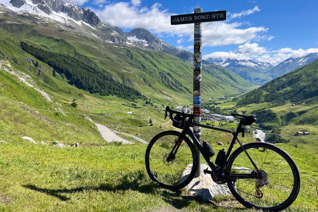 Factor bicycle leaning against the James Bond Street post sign on the Furkapass
