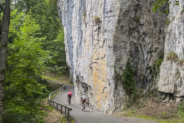 Two cyclists climbing the bike path on the south side of Lake Brienz, Switzerland
