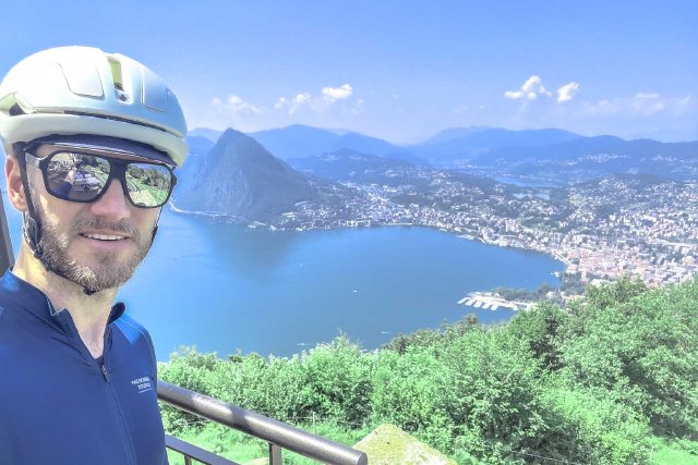Cyclist in sunglasses at the top of Monte Bré in Lugano, Switzerland