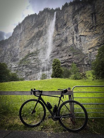 Pictures can't do this justice, it was so huge in person! View of bike leaning against a railing in front of Staubbachfall, Lauterbrunnen.