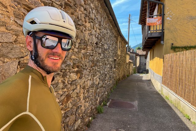 Cyclist selfie in front of a cobble-lined street in the Italian portion of Switzerland