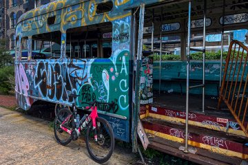 Factor Monza bicycle in front of an old train car covered in graffiti near Red Hook in Brooklyn, NY.