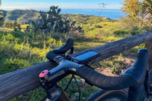 View of bicycle handlebars with a view of the Pacific Ocean at the top of Tuna Canyon Road in Los Angeles